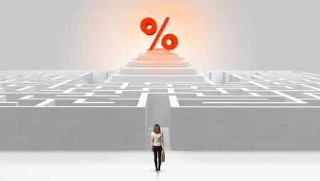 Man standing in front of a big round maze with profit concept on the middleの写真素材