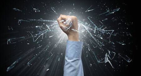 Big hand hits intense and breaks glassesの写真素材