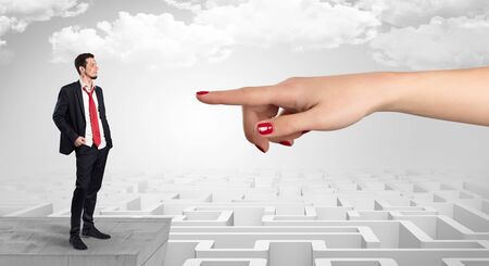 Young businessman blindly in love in the middle of an infinity maze conceptの写真素材