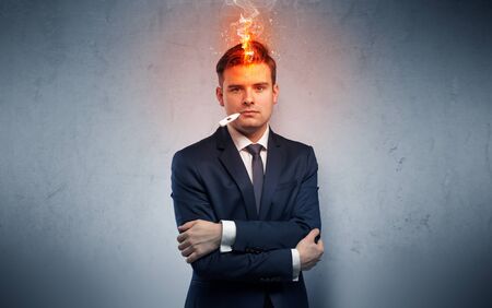Fever businessman with burning head conceptの写真素材