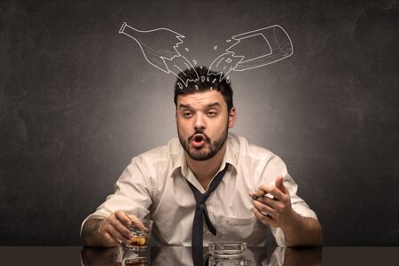 Drunk down and out man with doodle alcohol bottles conceptの写真素材