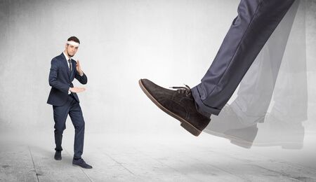 Big foot trample young suited karate manの写真素材