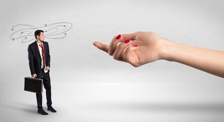 Foolish blind businessman in love going after big naked handの写真素材