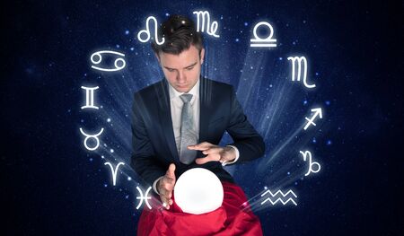 Young handsome astronaut looking for inspiration in his crystal magic ballの写真素材