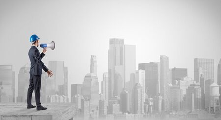 Architect standing on maze and looking at a future planの写真素材