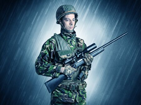 Armed soldier standing in rainy weather