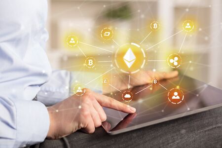 Business woman using tablet with cryptocurrency bitcoin link network and online conceptの写真素材