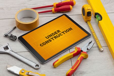 Tablet and tools with home under construction conceptの写真素材