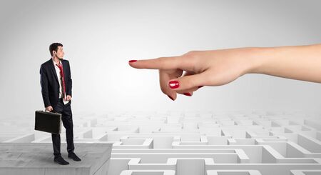 Young businessman blindly in love in the middle of an infinity maze conceptの写真素材