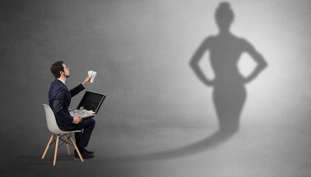 Rich businessman staying and offering stuffs to a pretty shadow womanの写真素材