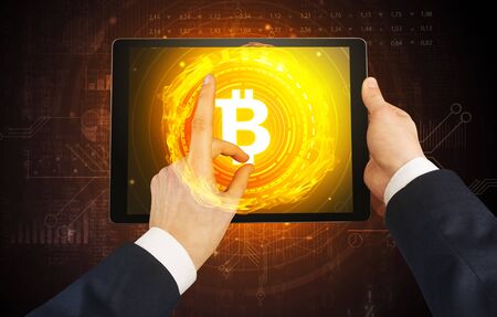 Elegant hand touching tablet with cryptocurrency conceptの写真素材