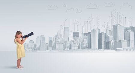 Cute little girl looking through spyglass to a big cityの写真素材