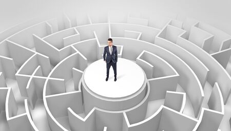 Businessman standing on the top a maze and looking throughの写真素材