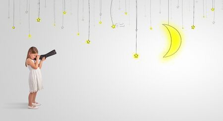 Cute little girl looking through spyglass to lighting bulbsの写真素材