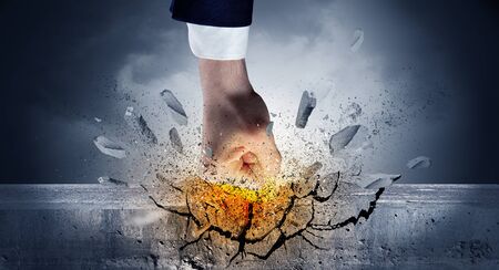 Big hand hits intense and breaks a crass stonewallの写真素材