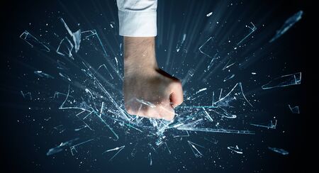 Big hand hits intense and breaks glassesの写真素材