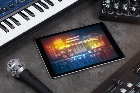 Electronic music instruments, microphone, piano, consoles and tablet with reports conceptの写真素材