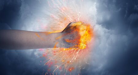 Hand hits strongly and makes fire beam aroundの写真素材