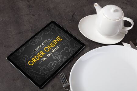 Tablet with online order concept on a lain tableの写真素材