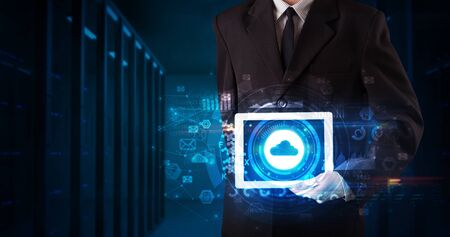 Hand holding tablet with cloud technology and dark conceptの写真素材