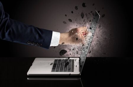 Strong male hand breaks laptop screen glassesの写真素材