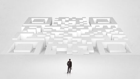 Businessman standing and thinking in top of a huge mazeの写真素材