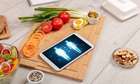 Arrangement of healthy Ingredients with a tablet. Dieting conceptの写真素材