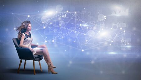 Elegant woman sitting in a sofa with network and connection conceptの写真素材
