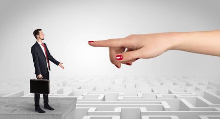 Young businessman blindly in love in the middle of an infinity maze conceptの写真素材