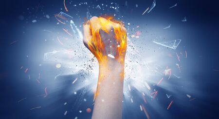 Hand hits strongly and makes fire beam aroundの写真素材