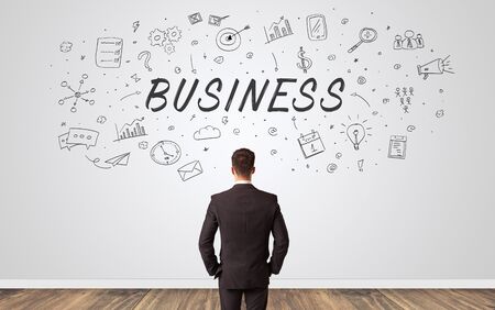 Young manager in doubt looking to a wall with business conceptの写真素材