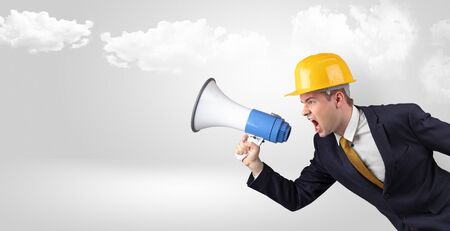 Young supervisor architect yelling to far big city panoramaの写真素材