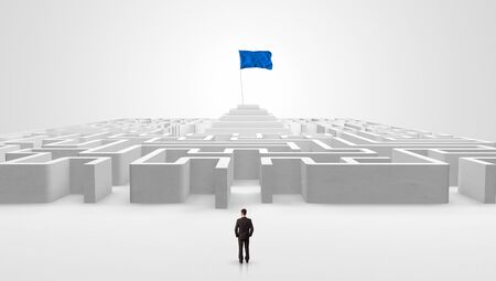 Man standing in front of a big round maze with pirate flag in the centerの写真素材