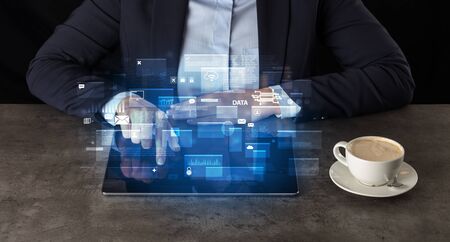 Business woman working on tablet with global database concept and dark backgroundの写真素材