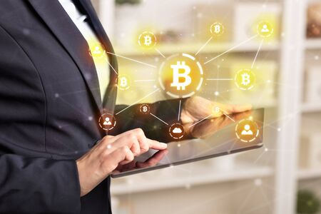 Business woman using tablet with cryptocurrency bitcoin link network and online conceptの写真素材
