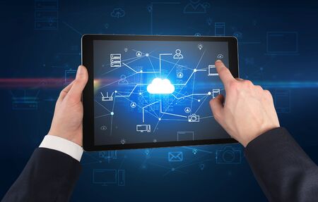 First person view of a hand using tablet with cloud office conceptの写真素材