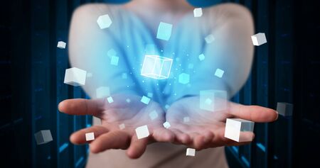 Person holding hologram projection displaying white cubes in server roomの写真素材