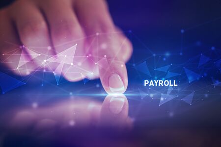 Finger touching tablet with PAYROLL inscription, business conceptの写真素材
