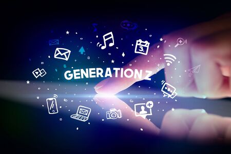Finger touching tablet with drawn social media icons and GENERATION Z inscription, social networking conceptの写真素材