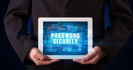 Young business person working on tablet and shows the digital sign: PASSWORD SECURITY