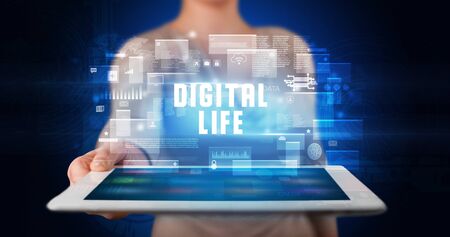 Young business person working on tablet and shows the digital sign: DIGITAL LIFEの写真素材