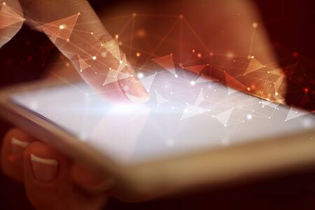 Finger touching phone with human network concept and dark backgroundの写真素材