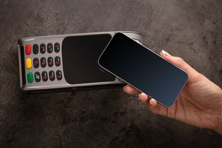 Hand pays with empty screen cellphone