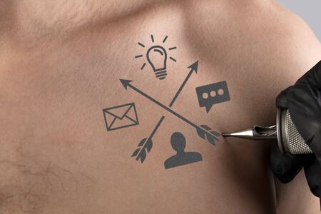 Hand tattooing colorful communication, leadership and creativity concept on naked clear skinの写真素材