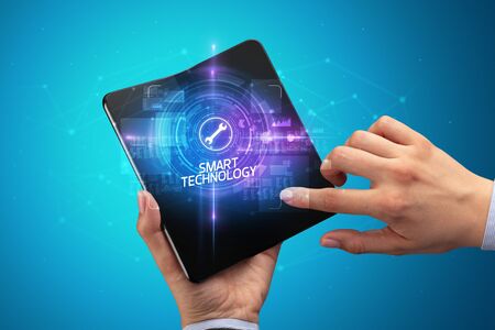 Businessman holding a foldable smartphone with TESTING inscription, new technology concept SMART...