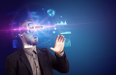 Businessman looking through Virtual Reality glasses with OUR VISION inscription, new business conceptの写真素材