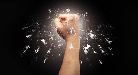 Big hand hits intense and breaks glassesの写真素材
