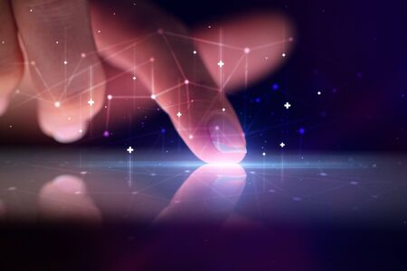 Finger touching tablet with global network concept and dark background
