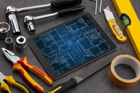 Tablet with construction tools and blueprint conceptの写真素材