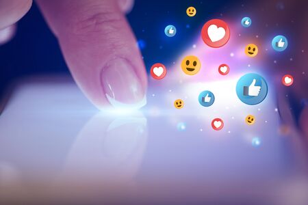 Finger touching phone with social media concept and dark background